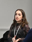 Image of woman speaking at a conference panel discussion