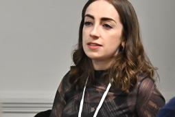 Image of woman speaking at a conference panel discussion